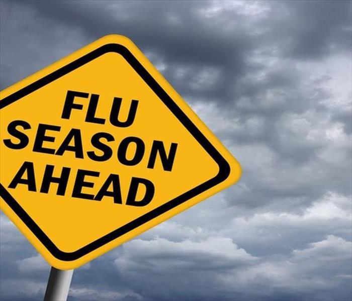 A big yellow sign that says Flu Season Ahead